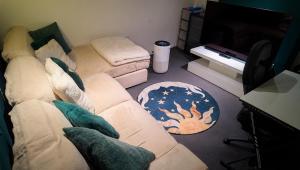 a living room with a couch and a television at Luxurious Modern Town House in Gillingham