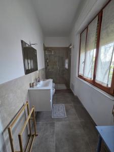 a bathroom with a white sink and a shower at FasHion HOme in Ameglia