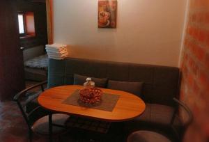 a table in a living room with a couch at Lipora apartman in Vrnjačka Banja +9 photos
