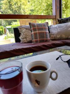a cup of coffee on a table next to a couch at Lipora apartman in Vrnjačka Banja
