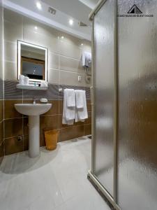 a bathroom with a shower and a sink and a mirror at Grand Museum with Pyramids view inn in Cairo +72 photos
