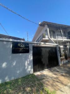 a house with a gate and a sign on it at Residencial Mandi in Guaíra