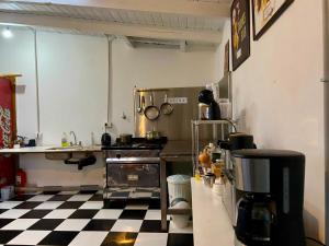 a kitchen with a checkered floor and a kitchen with a stove at Casa central hostel in San Carlos de Bariloche