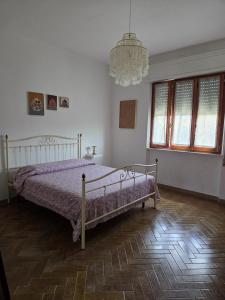 a bedroom with a bed and a chandelier at FasHion HOme in Ameglia