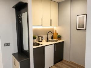 a small kitchen with a sink and a counter at Batumi - Seaside Stunning Apartment in Batumi