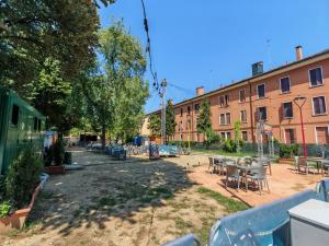 a courtyard with tables and chairs and buildings at Casa di Serena in Mestre