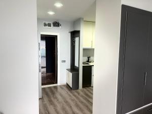 an empty room with a kitchen and a hallway at Batumi - Seaside Stunning Apartment in Batumi +4 photos