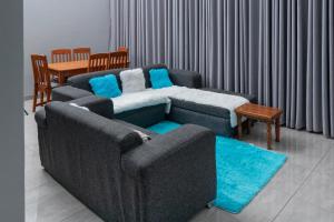 a living room with a couch and a table at Naomy's Place in Harare