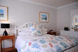 a bedroom with a bed with a floral bedspread at Short Strand Dingle in Dingle