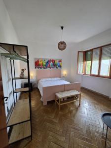 a bedroom with a bed and a table and a mirror at FasHion HOme in Ameglia