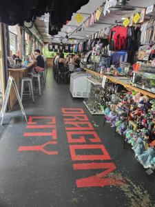 a store with a sale sign on the floor of a market at Dragon City in Maryville