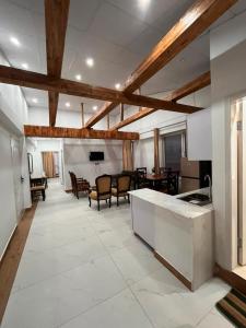 a large room with a kitchen and a living room at Pine Cottage in Murree