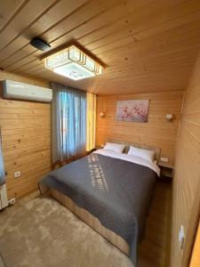 a bedroom with a large bed in a wooden room at Shtil in Kyiv +59 photos
