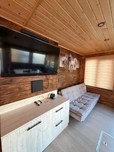 a living room with a large flat screen tv on the wall at Shtil in Kyiv