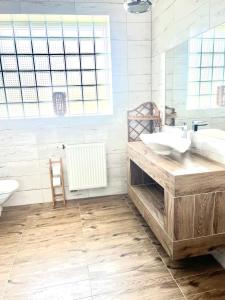 a bathroom with a sink and a tub and a toilet at City Centre Balcony Apartments in Wadowice +16 photos