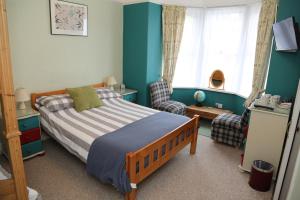 A bed or beds in a room at Acorns Guest House