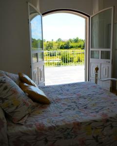 a bedroom with a bed and an open door at Vivenda Varandas in Lagoaça +41 photos