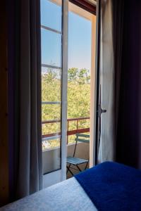 a bedroom with a door open to a balcony at Most Art Boutique Hostel in Leiria