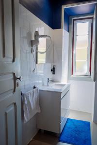 a bathroom with a sink and a mirror and a window at Most Art Boutique Hostel in Leiria +152 photos