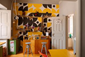 a kitchen with a cow painted on the wall at Most Art Boutique Hostel in Leiria