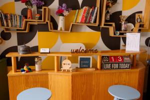 a room with two chairs and a shelf with books at Most Art Boutique Hostel in Leiria