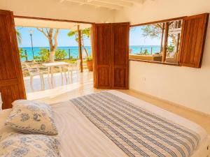a bedroom with a bed and a view of the ocean at Isla Risa in Cartagena de Indias