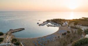 an aerial view of a beach with umbrellas and the ocean at Pearl House in Paralimni
