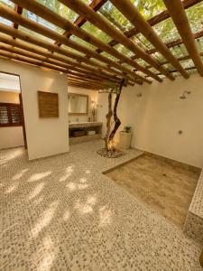 a room with a ceiling with a tree in it at Isla Risa in Cartagena de Indias