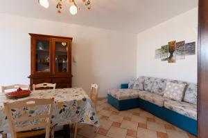 a living room with a couch and a table at Villa Nicole Vista Mare in Andrano