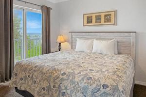 a bedroom with a large bed and a window at 501-S - Sunset Vistas in St. Pete Beach