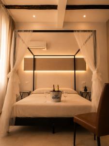 a bedroom with a bed with two wine glasses on it at RELAIS TORRE GLORIA in Naples