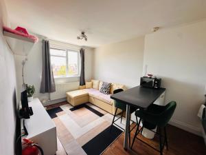 a living room with a couch and a table at Broadway Apartment in London
