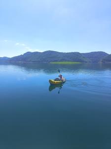 a person in a kayak on a body of water at Splav Maria-Zlatarsko jezero in Kokin Brod +4 photos