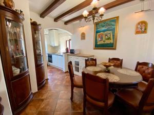 a kitchen with a dining room table and chairs at House with a pier in Donji Morinj
