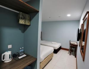 a hotel room with a bed and a small room with at Hotel La ISRA at Kuala Lumpur in Kuala Lumpur