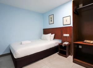 a bedroom with a bed and a telephone in it at Hotel La ISRA at Kuala Lumpur in Kuala Lumpur +27 photos