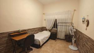 a bedroom with a bed and a desk and a table at Egypt holiday in Alexandria