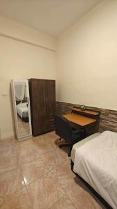 a bedroom with a desk and a bed and a bedroom with a bed sidx sidx at Egypt holiday in Alexandria