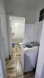 a bathroom with a sink and a toilet in it at Casa com piscina e próxima ao mar em Imbe in Imbé