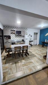 a living room with a table and a kitchen at Casa com piscina e próxima ao mar em Imbe in Imbé +17 photos