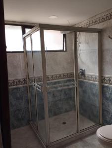 a shower with glass doors in a bathroom at Villa del Tesoro in El Poblado