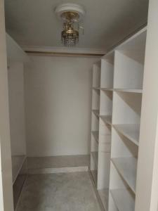 a room with white shelves and a chandelier at Villa del Tesoro in El Poblado +1 photo