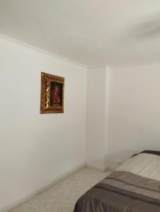 a bedroom with a painting hanging on the wall at Villa del Tesoro in El Poblado