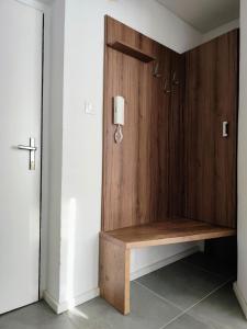 a wooden wall with a bench in a room at Studio11 in Medzilaborce