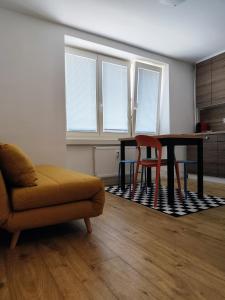 a living room with a table and a couch at Studio11 in Medzilaborce