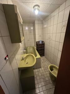a bathroom with a sink and a toilet at Workers House in Bockenem