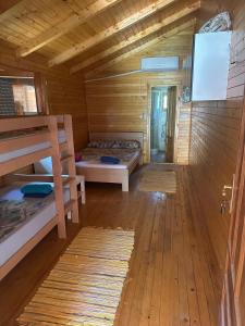 a room with two bunk beds in a cabin at Bojana Breeze in Ulcinj
