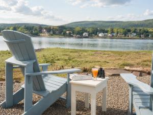 two chairs and a table with a glass of orange juice at Bailey House Inn - Georgian Waterfront Retreat in Annapolis Royal +7 photos