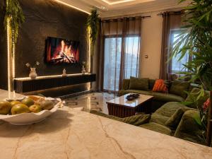 a living room with a couch and a bowl of fruit at Kaz An Nou in Cotonou