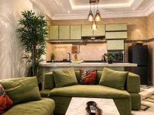 a living room with a couch and a kitchen at Kaz An Nou in Cotonou